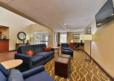 a living room with a couch and a table at Days Inn & Suites by Wyndham Manheim Lebanon in Manheim