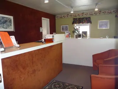 a waiting room with a counter and a chair at Red Rose Motel in Elizabethtown