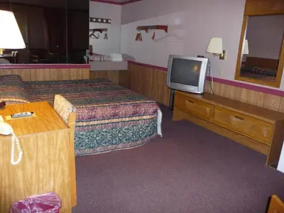 a hotel room with two beds and a tv at Red Rose Motel in Elizabethtown