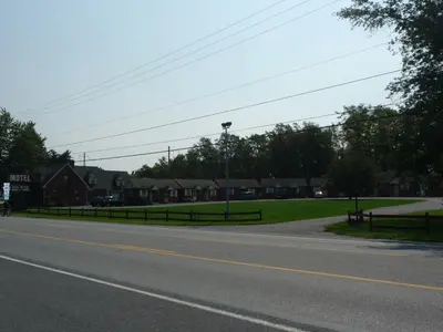 a street with houses and a road with a fence at Red Rose Motel in Elizabethtown