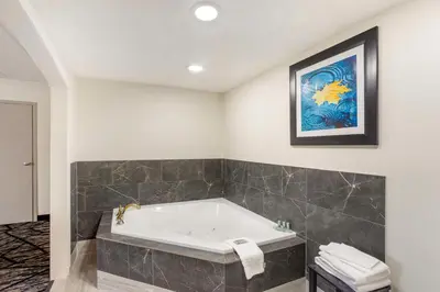 a bathroom with a tub and a painting on the wall at Best Western Westgate Inn in York