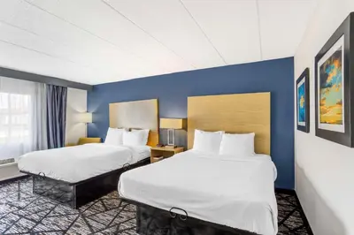 a hotel room with two beds and blue walls at Best Western Westgate Inn in York