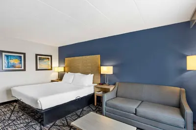 a hotel room with a bed and a couch at Best Western Westgate Inn in York