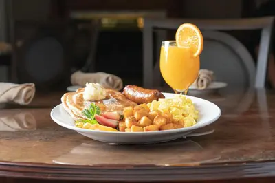 a plate of breakfast food and a glass of orange juice at Fulton Steamboat Inn in Lancaster