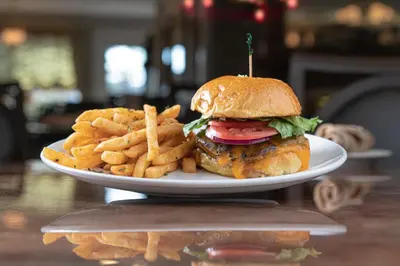 a plate with a chicken sandwich and french fries at Fulton Steamboat Inn in Lancaster