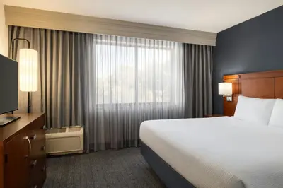 a hotel room with a bed and a window at Courtyard Mt. Holly Westampton in Westampton Township