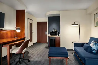 a living room with a couch and a desk in a room at Courtyard Mt. Holly Westampton in Westampton Township
