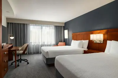 a hotel room with two beds and a desk at Courtyard Mt. Holly Westampton in Westampton Township