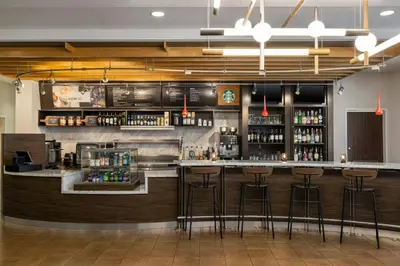 a bar in a restaurant with bar stools at Courtyard Mt. Holly Westampton in Westampton Township