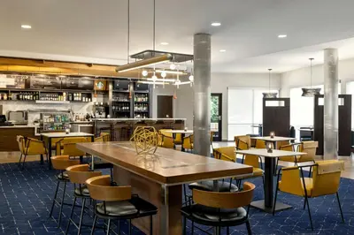 a dining room with tables and chairs in a restaurant at Courtyard Mt. Holly Westampton in Westampton Township
