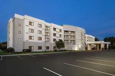 a large white building with a parking lot at Courtyard Mt. Holly Westampton in Westampton Township
