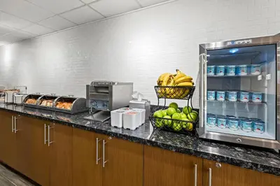 a kitchen with a counter with bananas and other foods at The Penn Stroud, Stroudsburg - Poconos, an Ascend Collection Hotel in Stroudsburg