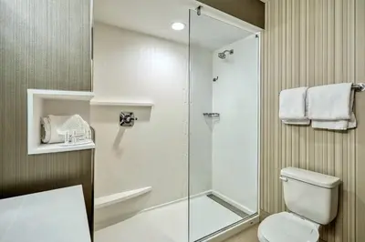 a bathroom with a shower and a toilet at Courtyard by Marriott North Brunswick in North Brunswick