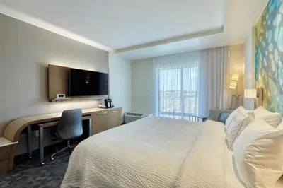a hotel room with a bed and a desk at Courtyard by Marriott North Brunswick in North Brunswick