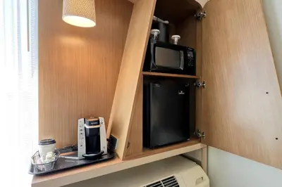 a kitchen with a microwave and a coffee maker at Courtyard by Marriott North Brunswick in North Brunswick
