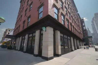 a large brick building on a city street at The Frederick Hotel Tribeca in New York