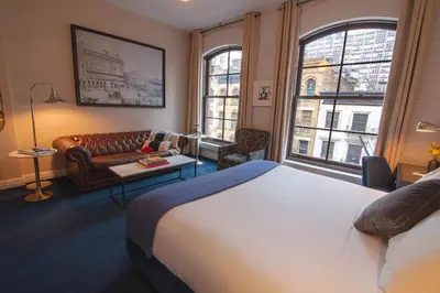 a hotel room with a bed and a couch at The Frederick Hotel Tribeca in New York