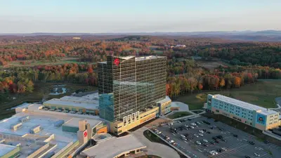 an overhead view of a tall building with a parking lot at Resorts World Catskills in Monticello