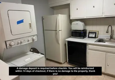 a kitchen with a white refrigerator and a sink at Artist in the Barn in Philadelphia