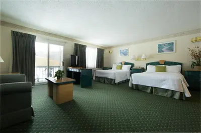 a hotel room with two beds and a television at Villa Roma Resort and Conference Center in Callicoon