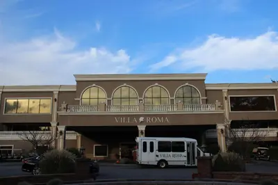 a white bus parked in front of a building at Villa Roma Resort and Conference Center in Callicoon