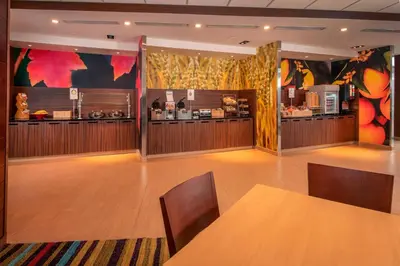 a dining room with a table and a kitchen at Fairfield Inn & Suites by Marriott Harrisburg International Airport in Middletown
