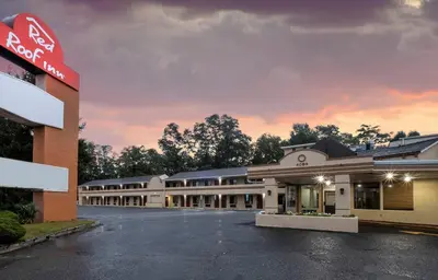 an empty parking lot in front of a building at Red Roof Inn Freehold in Freehold