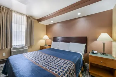 a hotel room with a bed and a window at Knights Inn Trevose in Trevose