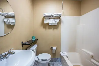 a bathroom with a sink and a toilet and a mirror at Knights Inn Trevose in Trevose