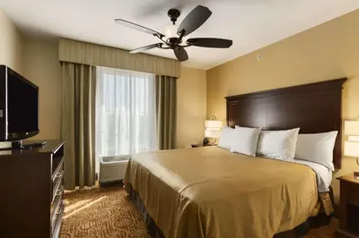 a hotel room with a bed and a ceiling fan at Homewood Suites by Hilton Binghamton/Vestal in Vestal