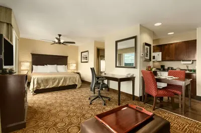 a hotel room with a bed and a desk at Homewood Suites by Hilton Binghamton/Vestal in Vestal