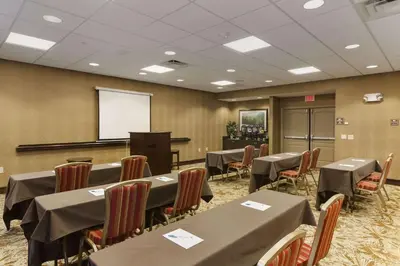 a conference room with tables and chairs and a whiteboard at Homewood Suites by Hilton Binghamton/Vestal in Vestal
