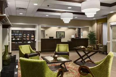 a waiting room with chairs and a table and a desk at Homewood Suites by Hilton Binghamton/Vestal in Vestal