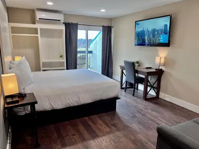 a hotel room with a bed and a desk and a television at Hershey Farm Resort in Ronks