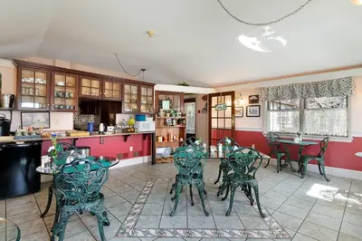 a kitchen with a table and chairs in a room at After Eight Bed and Breakfast in Ronks
