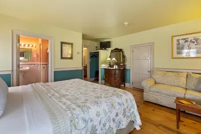a bedroom with a bed and a couch at After Eight Bed and Breakfast in Ronks