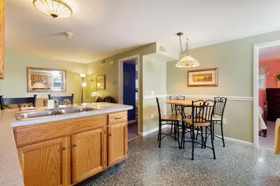 a kitchen with a sink and a table with chairs at After Eight Bed and Breakfast in Ronks