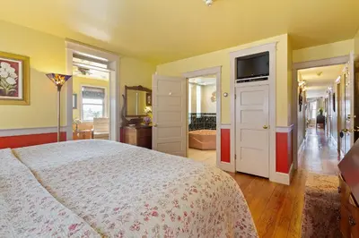 a bedroom with a large bed and a bathroom at After Eight Bed and Breakfast in Ronks