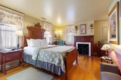 a bedroom with a bed and a fireplace at After Eight Bed and Breakfast in Ronks