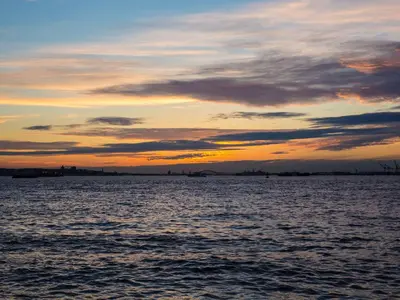 a sunset over a large body of water at The Lodge Red Hook in Brooklyn