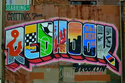 a wall with graffiti on the side of it at The Lodge Red Hook in Brooklyn