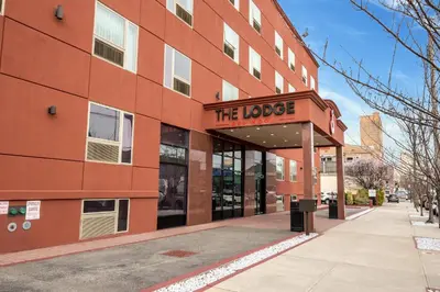 a building with a sign that reads the lodge at The Lodge Red Hook in Brooklyn