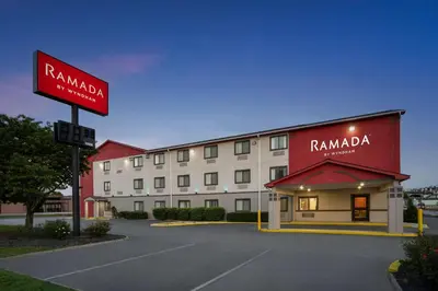 a hotel with a sign in front of a building at Ramada by Wyndham York Harrisburg Hershey in York