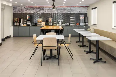 a dining room with tables and a counter at Ramada by Wyndham York Harrisburg Hershey in York