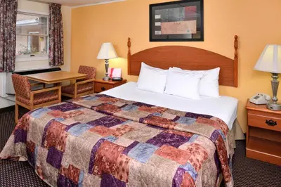 a hotel room with a bed and a desk at Red Carpet Inn Ronks in Ronks