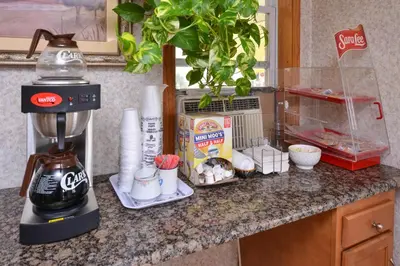 a counter with a coffee maker and other items on it at Red Carpet Inn Ronks in Ronks