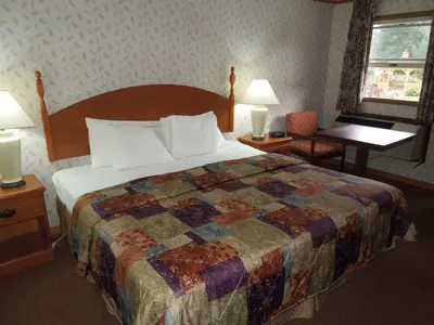 a bedroom with a bed and a table and a window at Red Carpet Inn Ronks in Ronks