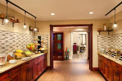 a large kitchen with wooden cabinets and a counter at Sheraton Great Valley Hotel in Frazer