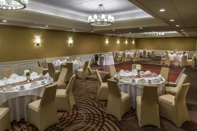 a banquet room with tables and chairs and tablesktop at Sheraton Great Valley Hotel in Frazer