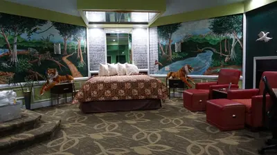a hotel room with a bed and a painting at Inn of the Dove Cherry Hill - Philadelphia in Cherry Hill